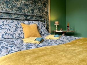 a bedroom with a bed with two pillows on it at Apartament Stary Zdrój in Wałbrzych +21 photos