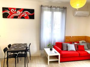 a living room with a red couch and a table at Blue Summer Vibes Duplex Studio for 4P, AC, sea view, parking, beach at 50m, SPA access -3 in La Ciotat