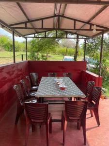 a patio with a table and chairs on a patio at Wild Valley Club in Masinagudi