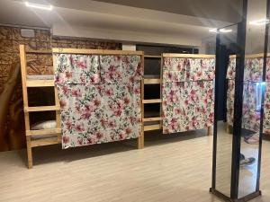 a room with three sets of curtains with flowers at Unique City Hostel 100 meters from Beach in Larnaca
