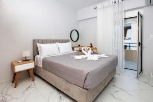 a bedroom with a bed with two swans on it at Casa di Vila in Rethymno