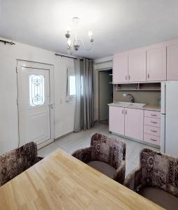 a kitchen with a table and chairs in a room at Maria's Dream House in Ierapetra +7 photos