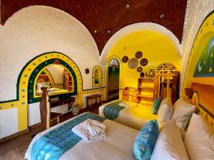a bedroom with two beds in a room with arches at Kato Dool Wellness Resort in Aswan