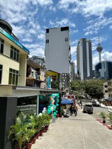 a street in a city with a building and plants at Hotel MSP in Kuala Lumpur