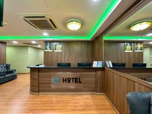 a hotel lobby with a reception desk with green lights at Hotel MSP in Kuala Lumpur