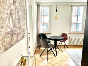 a dining room with a table and two chairs at RIVERSIDE - APARTMENTS BASEL deluxe in Basel