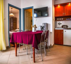 a table with a purple table cloth on it in a kitchen at Villa Gabriella - Vízparti in Balatonboglár