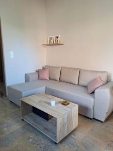 a living room with a couch and a coffee table at Maro Sweet Home in Aigio