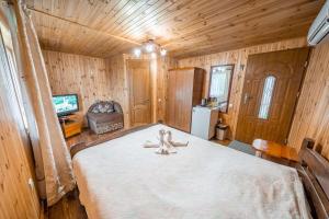 a bedroom with a bed with a teddy bear on it at Сосновий Бір, Світязь in Svityazʼ +35 photos