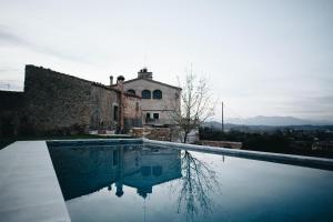 a house with a swimming pool in front of it at Can Campolier in Porqueres