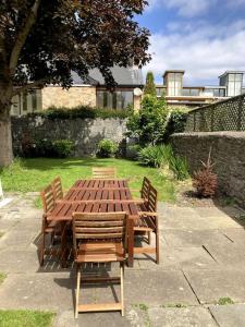 a wooden table and chairs in a yard at Family home in the heart of Dublin in Dublin
