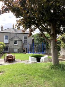 a house with a tree and a table and a playground at Family home in the heart of Dublin in Dublin