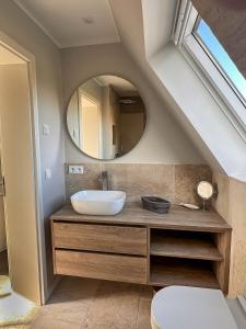 a bathroom with a sink and a mirror at 2Land in Sicht in List