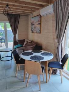 a living room with a table and chairs and a couch at SOSNOWY KLIFF in Niechorze