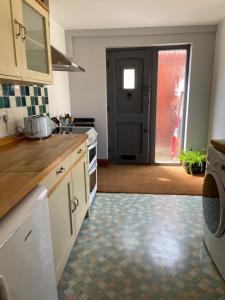 a kitchen with a sink and a stove top oven at Kings Arms Annex in Steventon