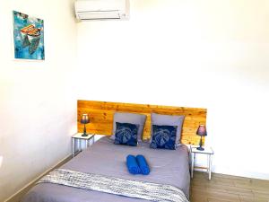 a bedroom with a bed with blue shoes on it at Blue Summer Vibes Apartment for 4P, AC, balcony, parking, beach at 50m, SPA access -4 in La Ciotat