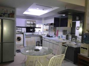 a kitchen with a glass table and chairs in it at Mitra @Guesthouse B28-S in Batam Center +11 photos