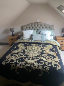 a bedroom with a black and gold bed with pillows at Cornerstone House in Pickering