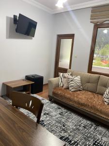 a living room with a couch and a table at Uzungol Soylu Hotel in Uzungöl