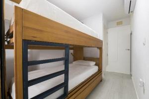 a couple of bunk beds in a room at AMANECER BOUTIQUE HOME, BEACH, Village & RELAX in Chiclana de la Frontera