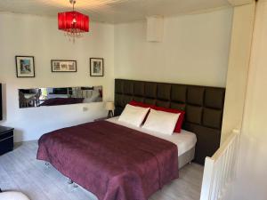 a bedroom with a large bed with a red blanket at Old town castle house-detached house in Marmaris