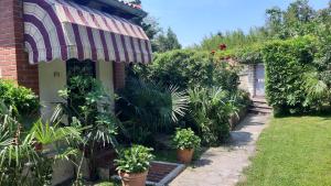 a house with an awning and plants in a yard at APARTMA ERNESTINO in Portorož