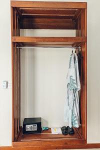 a mirror in a room with a clock and shoes at Taj Maza Sunset Villas in Gili Trawangan