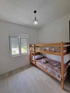 a bedroom with two bunk beds and a window at VistaRelax in Trebinje