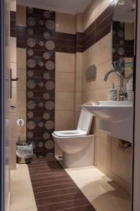 a bathroom with a toilet and a sink at Glamour beautique villa in Akharnaí