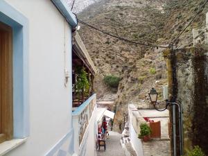 a narrow street in positano with a mountain in the background at Olympos apt with amazing mountain view in Olympos