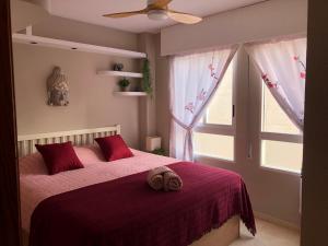 a bedroom with a bed with a red blanket and a window at Apartment RoSol Albir Playa in Albir