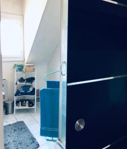 a blue door in a room with a staircase at Au pied du circuit des 24h, chez Céline in Le Mans