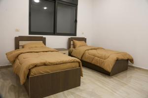 מיטה או מיטות בחדר ב-Mobes Resort -منتجع موبص
