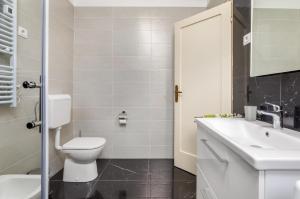a bathroom with a toilet and a sink at Apartman Darija in Vodnjan +15 photos