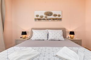 a bedroom with a bed and two tables with lamps at Apartman Darija in Vodnjan