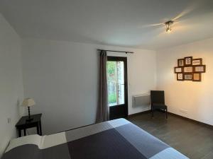 a bedroom with a bed and a window at CAP CORSE - SISCO - MAISON DE CHARME 6 PERSONNES in Sisco