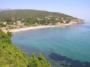 a beach with a group of people in the water at CAP CORSE - SISCO - MAISON DE CHARME 6 PERSONNES in Sisco