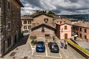 two cars parked in a parking lot in a town at Romantic apartment with terrace in Nievole