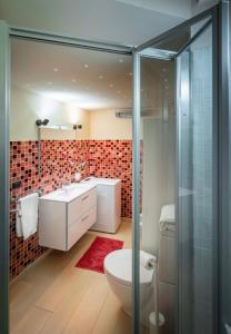a bathroom with a toilet and a glass shower at Romantic apartment with terrace in Nievole