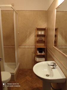 a bathroom with a sink and a shower and a toilet at Zé Inácio - Alojamento e Restaurante in Porto Covo