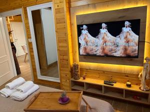 a living room with a flat screen tv on a wall at Vila Lulebore in Velipojë