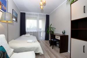 a hotel room with two beds and a desk and a desk at Samodzielne 3-pokojowe mieszkanie blisko plaży in Ustka