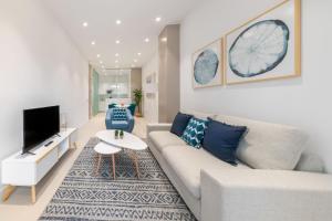 a living room with a couch and a tv at 2 bedrooms 2 bathrooms furnished - Delicias - modern- MintyStay in Madrid