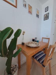 a dining room with a wooden table and a cactus at Comfortable Lucy apartment with amazing sea-view in Puerto del Carmen