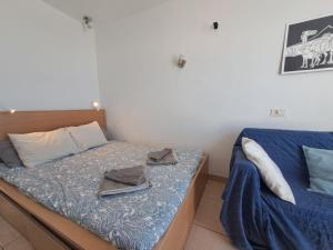 a bedroom with a bed with towels on it at Comfortable Lucy apartment with amazing sea-view in Puerto del Carmen
