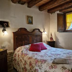 a bedroom with a bed with a red pillow on it at B&B Santa Brigida in Santa Brigida