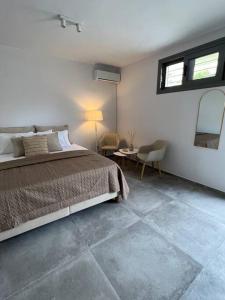 a bedroom with a bed and a table and a window at Modern & Cozy Studio in Koroni