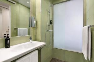 a bathroom with a sink and a shower at Super 8 by Wyndham Koblenz in Koblenz