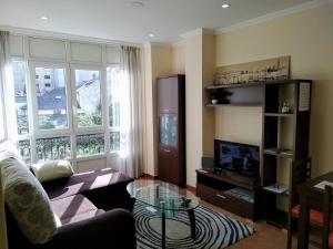 a living room with a couch and a glass table at Ribadeo Centro in Ribadeo