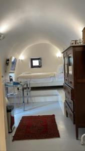 a hospital room with a bed and a dresser at Villetta Erato,picturesque studio in Chalki in Halki